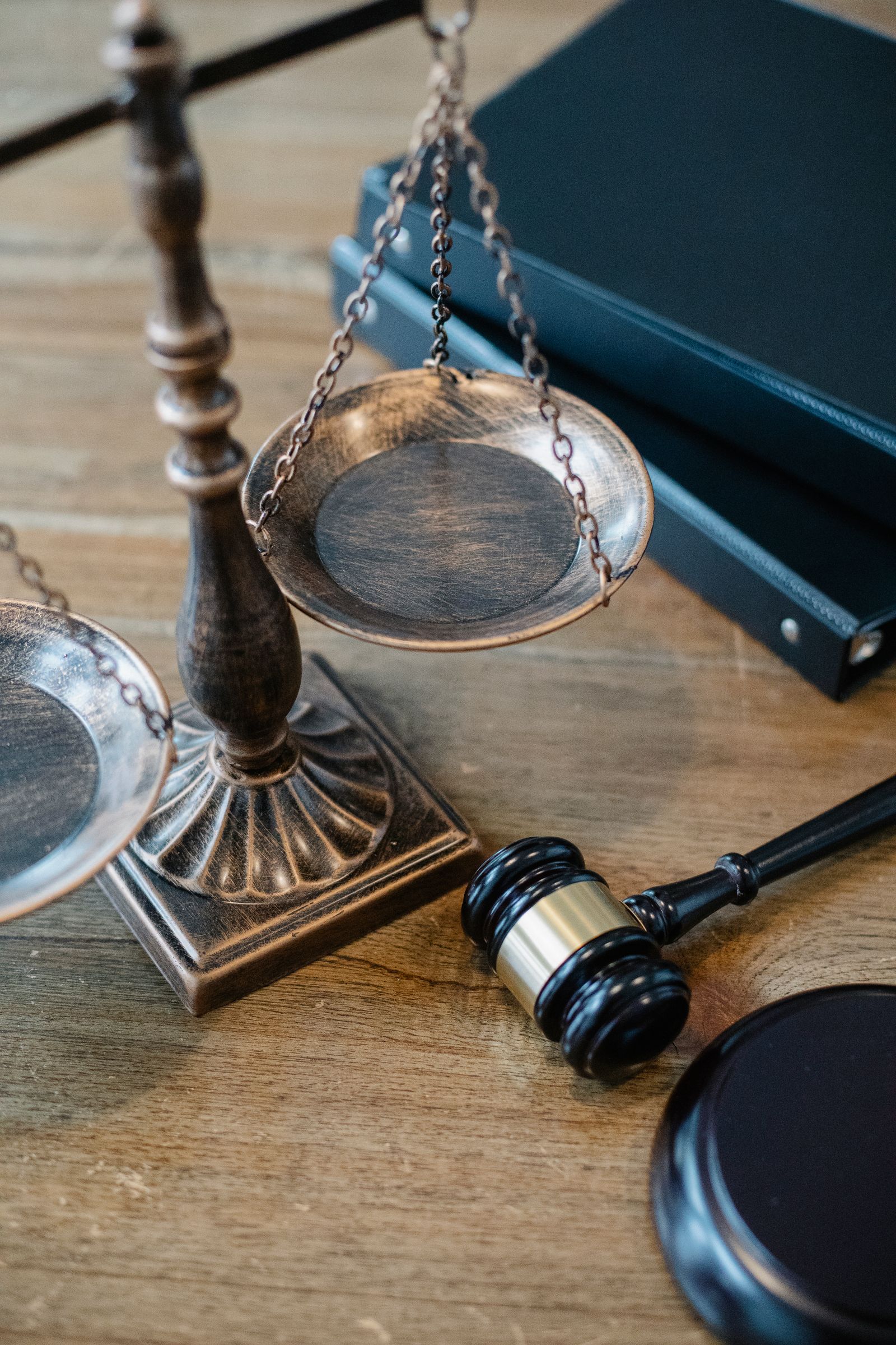 Antique scales of justice beside law books and a gavel
